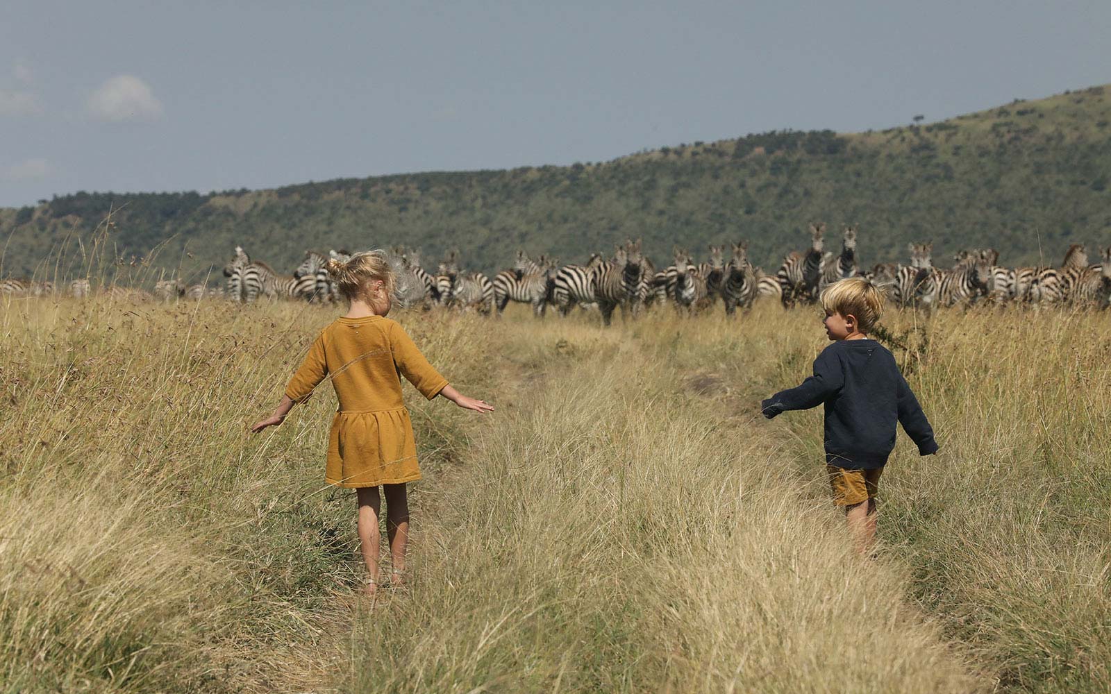 image of 2 children in tall prairie grass